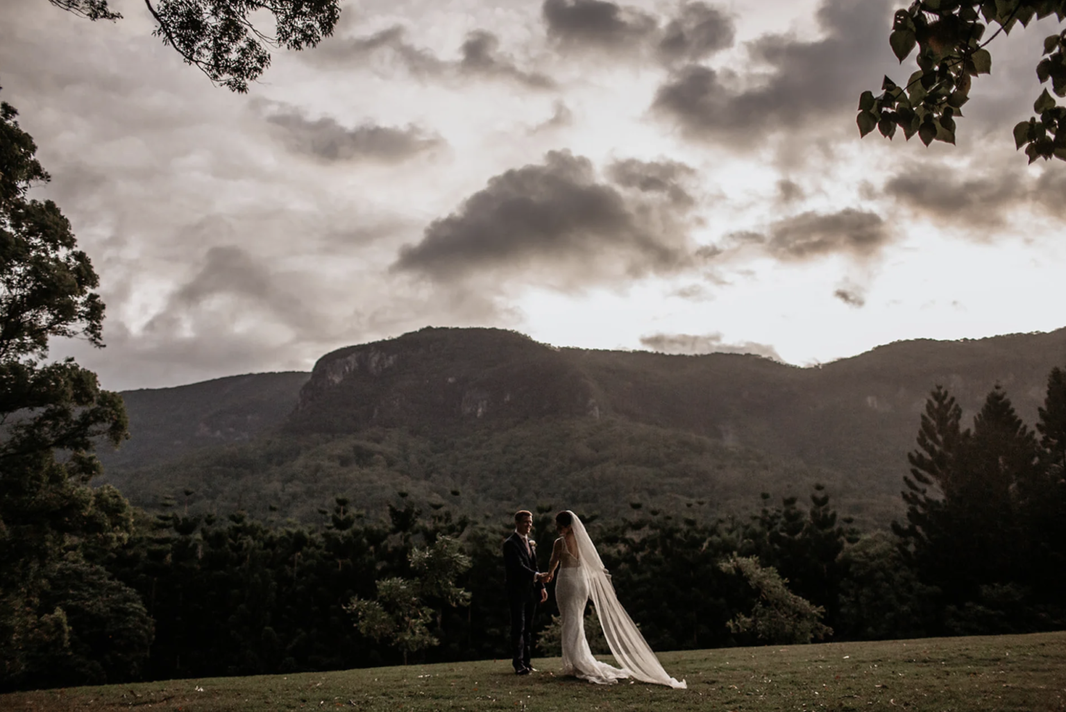 Couple on the lawn with the mountains behind at The Bower Estate